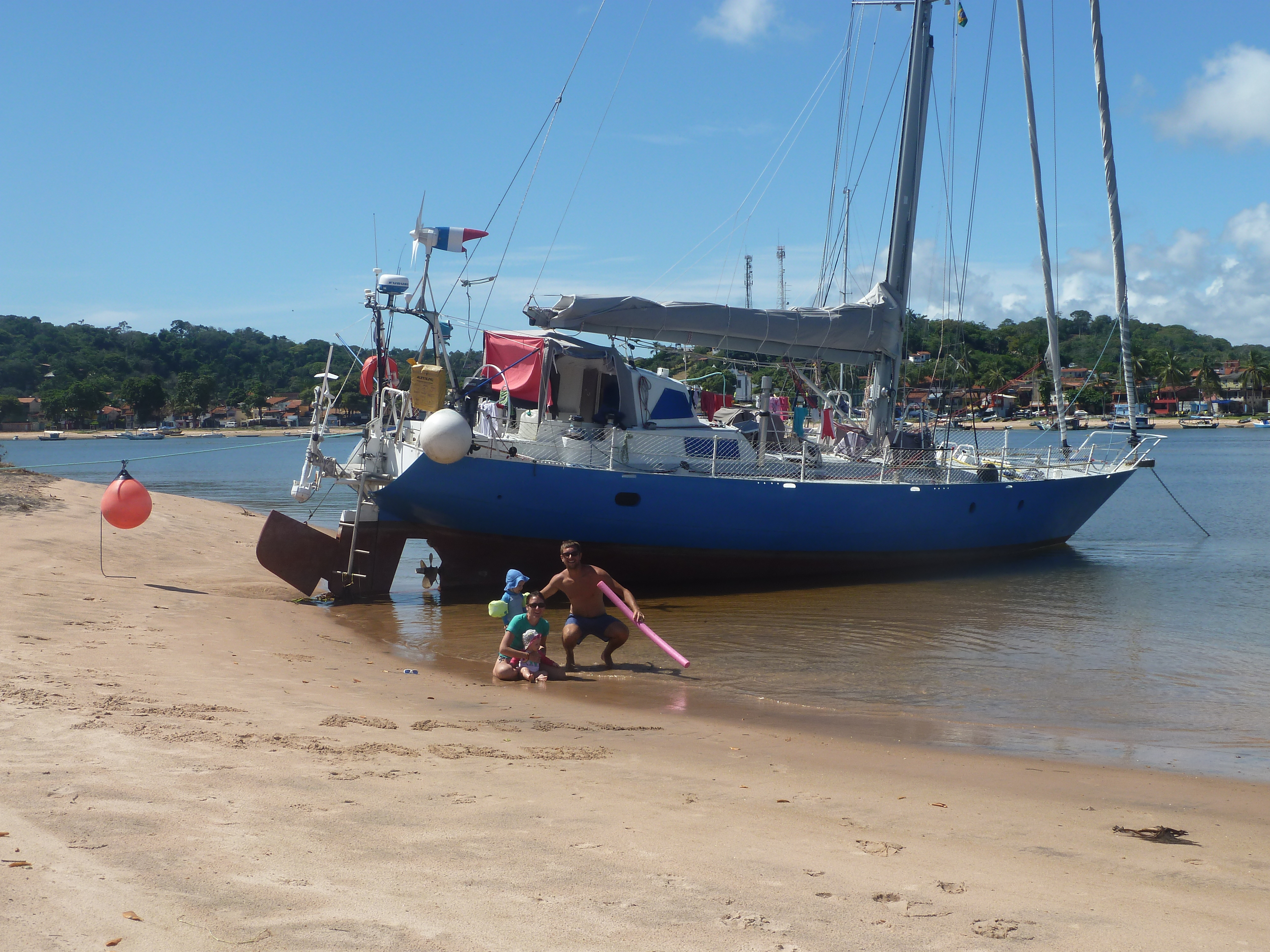 The crew in front of Libertaire on Christmas Day on the beach of Itacare